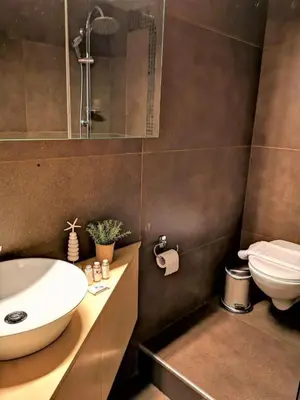 a bathroom with a sink and a toilet at Alendra's City Center Studio in Chania Town