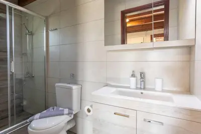 a bathroom with a toilet and a sink at Rose of Crete in Plataniás