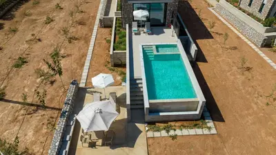 an overhead view of a swimming pool next to a house at Fairytale Villas in Souda