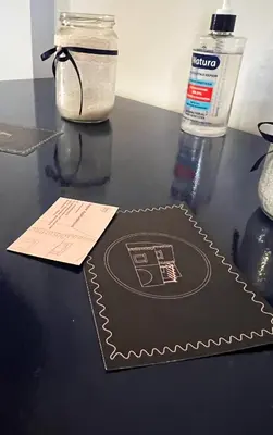 a black table with a bottle of water and a napkin at Pink House in Palaiochóra