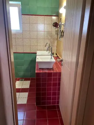 a bathroom with a sink and a mirror at Pink House in Palaiochóra