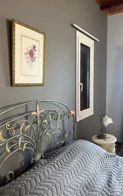 a bedroom with a bed and a picture on the wall at Pink House in Palaiochóra