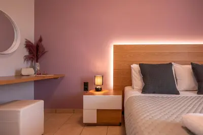 a bedroom with a bed and a table with a lamp at Alexandros Luxury House in Falasarna