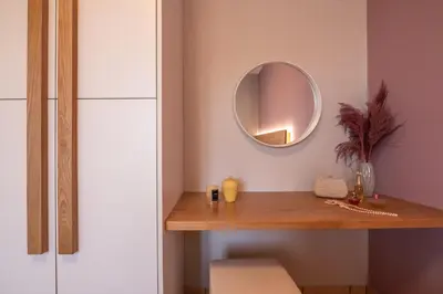 a dressing table with a mirror on a wall at Alexandros Luxury House in Falasarna