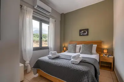 a bedroom with a bed with towels on it at Alexandros Luxury House in Falasarna