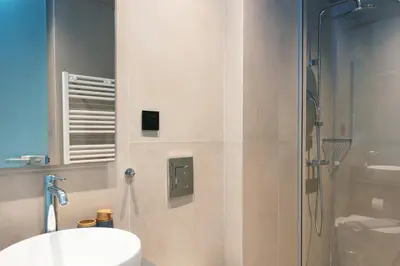a bathroom with a shower and a toilet and a sink at Souda Plaza Collection in Souda