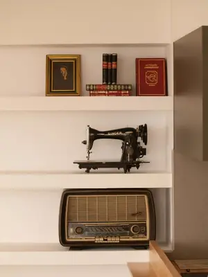 a sewing machine on a shelf above a radio at The Garden of Zephyrus - East in Pithárion