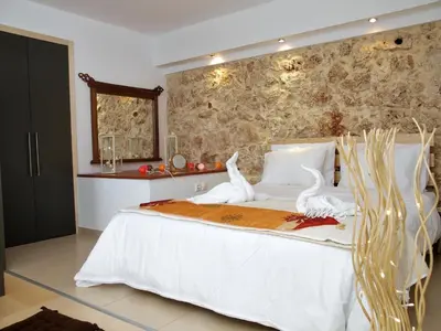 a bedroom with a white bed with white birds on it at The Garden of Zephyrus - East in Pithárion
