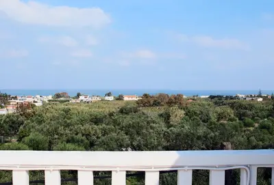 a view of the city from the balcony of a house at Kouros Chania Villas in Maleme