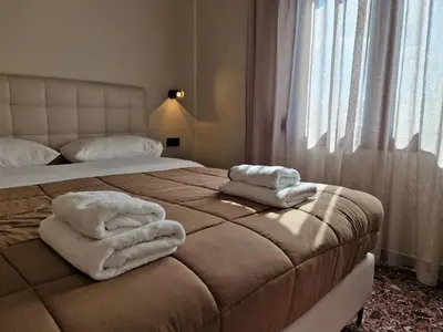 a bedroom with a bed with towels on it at Mosaic Apartments in Chania Town