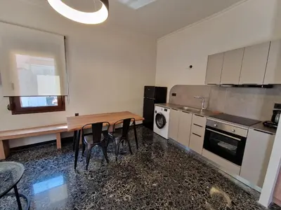 a kitchen with a wooden table and chairs in a room at Mosaic Apartments in Chania Town