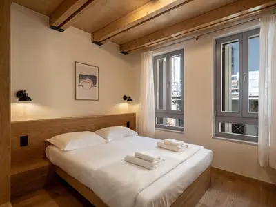 a bedroom with a bed with two towels on it at Austrinus house, luxury property for max. 5 persons in Chania Town