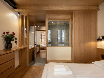 a bedroom with wooden walls and a bed with a window at Austrinus house, luxury property for max. 5 persons in Chania Town
