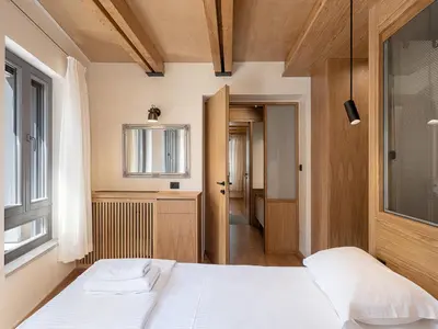 a bedroom with two beds and a window at Austrinus house, luxury property for max. 5 persons in Chania Town