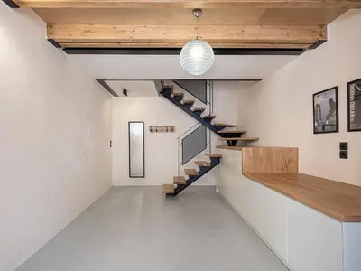 a staircase in a room with white walls and wooden ceilings at Austrinus house, luxury property for max. 5 persons in Chania Town