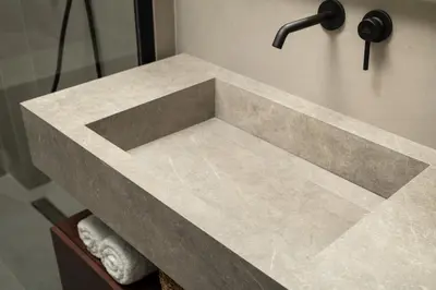 a bathroom with a marble sink with a faucet at KOEV slow living in Tsikalariá