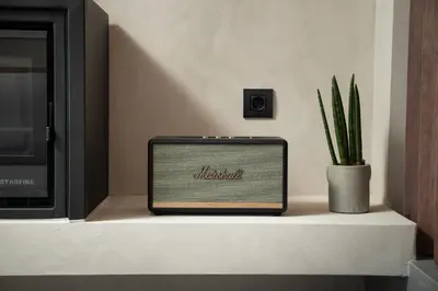 a radio sitting on a shelf next to a plant at KOEV slow living in Tsikalariá