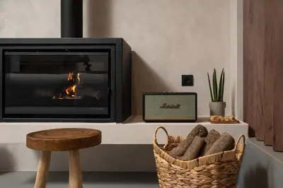 a living room with a fireplace and a basket of bread at KOEV slow living in Tsikalariá