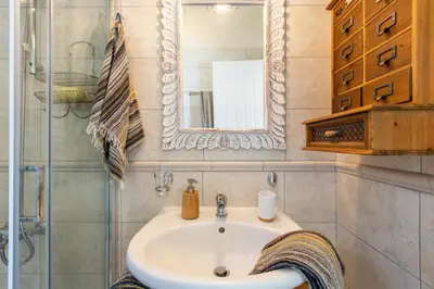 a bathroom with a sink and a mirror at Villa Henry Darmarohori in Darmarochori