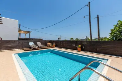 a swimming pool on the side of a house at Villa Henry Darmarohori in Darmarochori