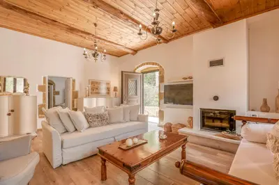 a living room with a couch and a table at Pool Villa Michail, in Kissamos! in Koukounará