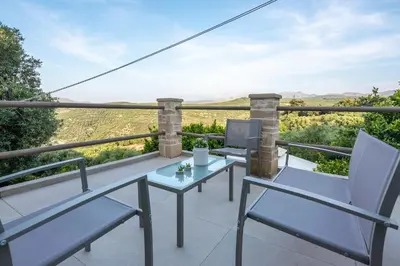 a balcony with chairs and a table with a view at Pool Villa Michail, in Kissamos! in Koukounará