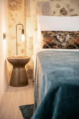 a bedroom with a bed and a nightstand next to a bed at Malmáki, a street view apartment in Chania Town
