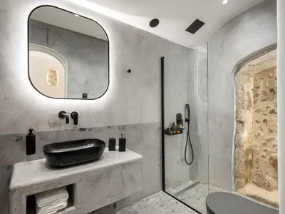 a bathroom with a sink and a mirror at Malmáki, a street view apartment in Chania Town