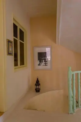 a room with a staircase and a picture on the wall at History & Culture in Old Town Chania in Chania Town