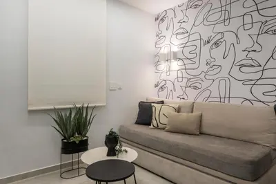 a living room with a couch and a black and white wall at Pi Suite Project Smart Living in Chania Town