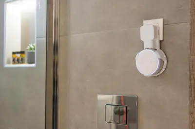 a bathroom with a shower with a clock on the wall at Pi Suite Project Smart Living in Chania Town
