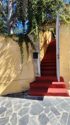 a red carpeted stairway leading to a building at Dominic Central Venetian Castle Old Port Apartment in Chania Town