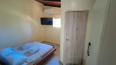 a small bedroom with a bed and a door at Dominic Central Venetian Castle Old Port Apartment in Chania Town