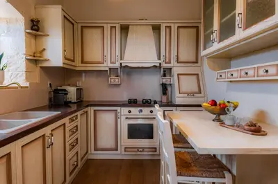 a kitchen with wooden cabinets and a counter top at Giovanta Villa in Kondomari