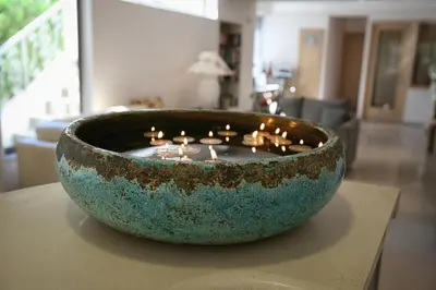 a bowl filled with candles sitting on top of a table at Flamingos Hotel Apartments in Kato Daratso