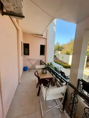 a balcony with a table and chairs on it at Tersanas Beach Apartments in Chorafakia