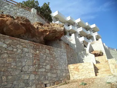 a building on top of a stone wall at Falasarna Bay in Falasarna