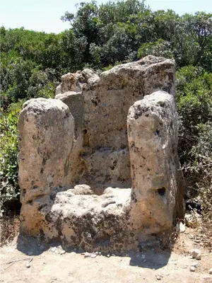 a large rock sitting on the side of a field at Falasarna Bay in Falasarna