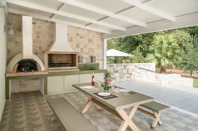 a large kitchen with a table and a stove at Villa Nature, Heated Pool in Kalyves