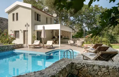 a villa with a swimming pool and a house at Villa Nature, Heated Pool in Kalyves