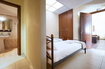 a bedroom with a bed and a bathroom at Villa Leon in Souda