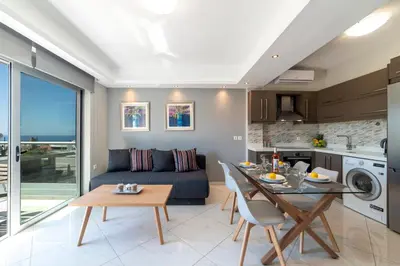 a kitchen and living room with a couch and a table at Sunshine Suite Family in Chania Town