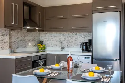a kitchen with a table with glasses of wine at Sunshine Suite Family in Chania Town