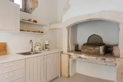 a kitchen with an oven and a sink in it at Tholos Cottage in Stérnai