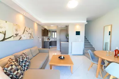 a living room with a couch and a table at Sunshine Suite Junior in Chania Town