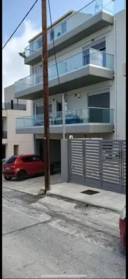 a red car parked in front of a building at Sunshine Suite Junior in Chania Town