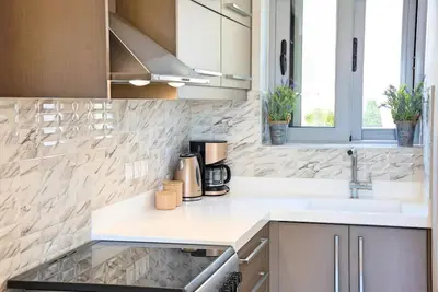 a kitchen with a sink and a counter top at Sunshine Suite Junior in Chania Town