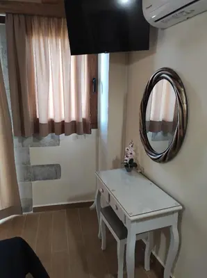 a room with a white table and a mirror at Castello casa in Perivólia