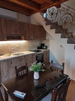 a kitchen with a table with a vase of flowers on it at Castello casa in Perivólia