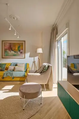 a living room with a couch and a chair at KaiZen Chania - New Central Apartment Just 350m Away With Private Jacuzzi and free parking! in Chania Town